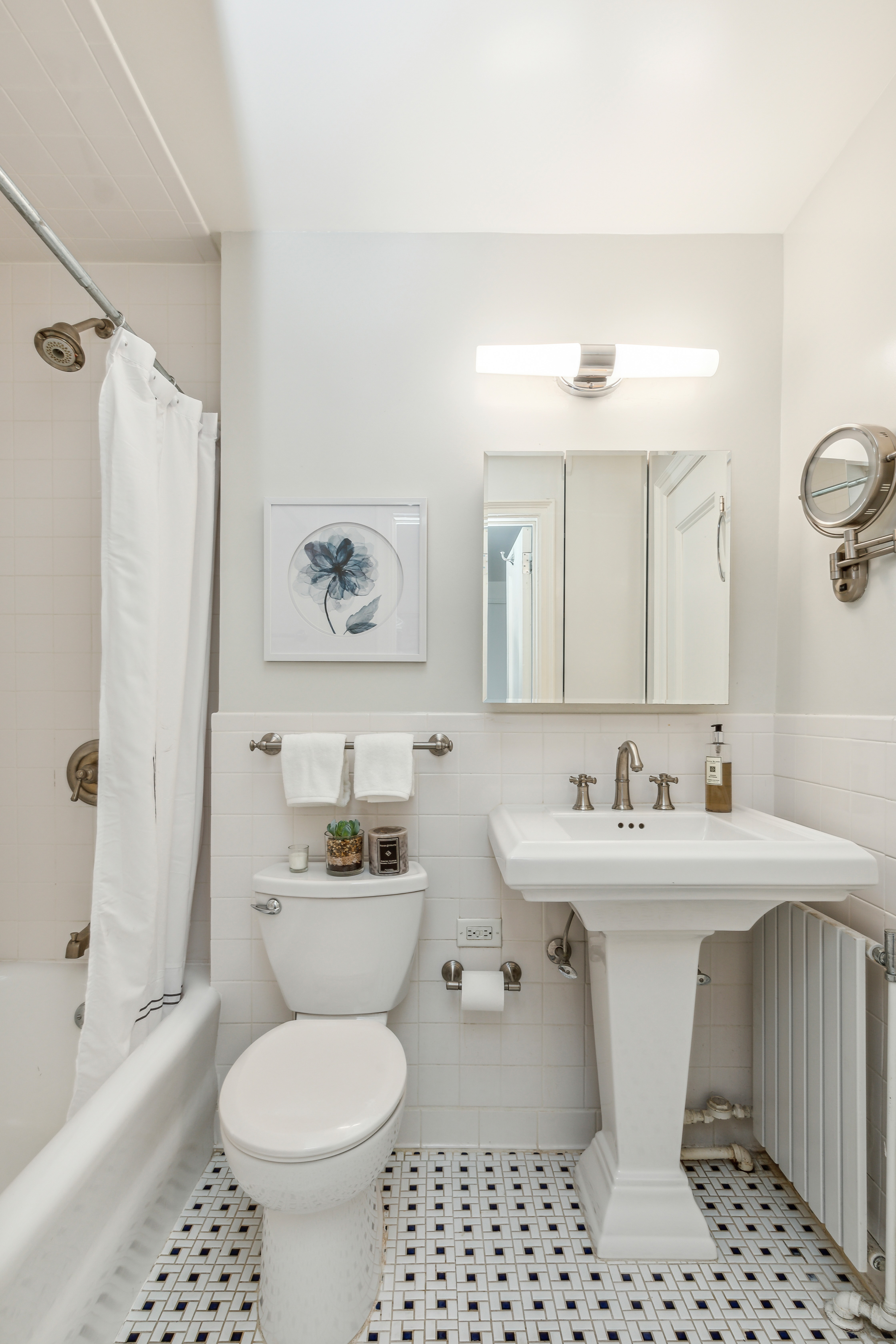 400 East 59th Street, Unit 2D Manhattan, NY 10022 - Photo 7 of 8 a bathroom with a sink toilet and shower