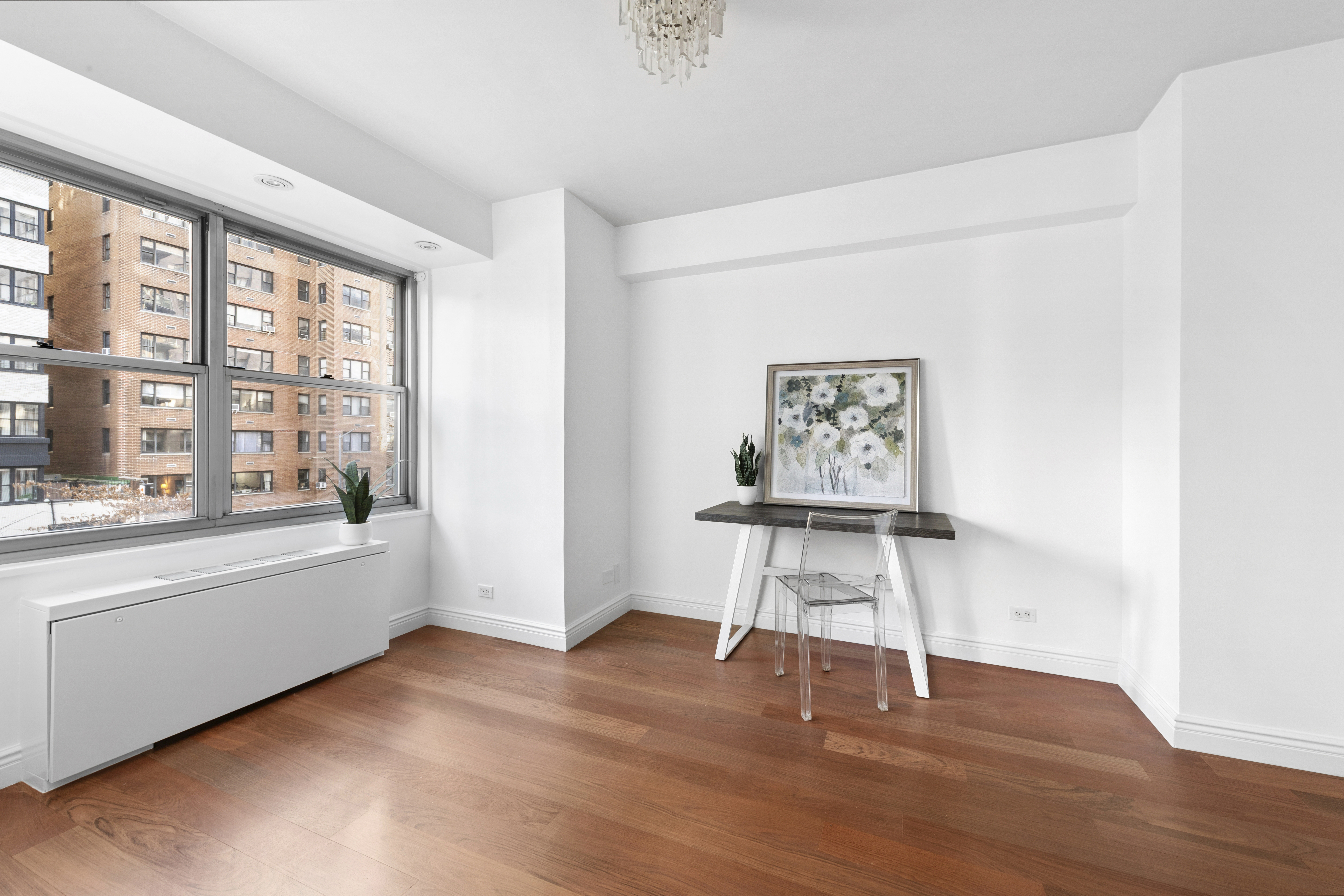 400 East 56th Street, Unit 3D Manhattan, NY 10022 - Photo 13 of 24 a view of an empty room with a window and wooden floor