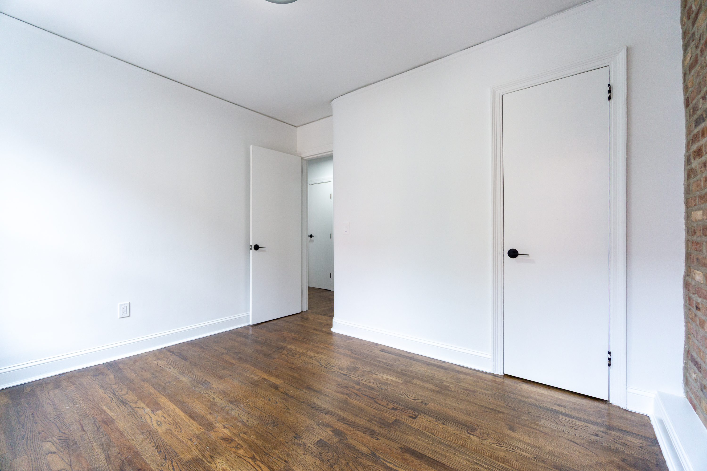 342 East 6th Street, Unit 3 Manhattan, NY 10003 - Photo 9 of 13 a view of an empty room with wooden floor