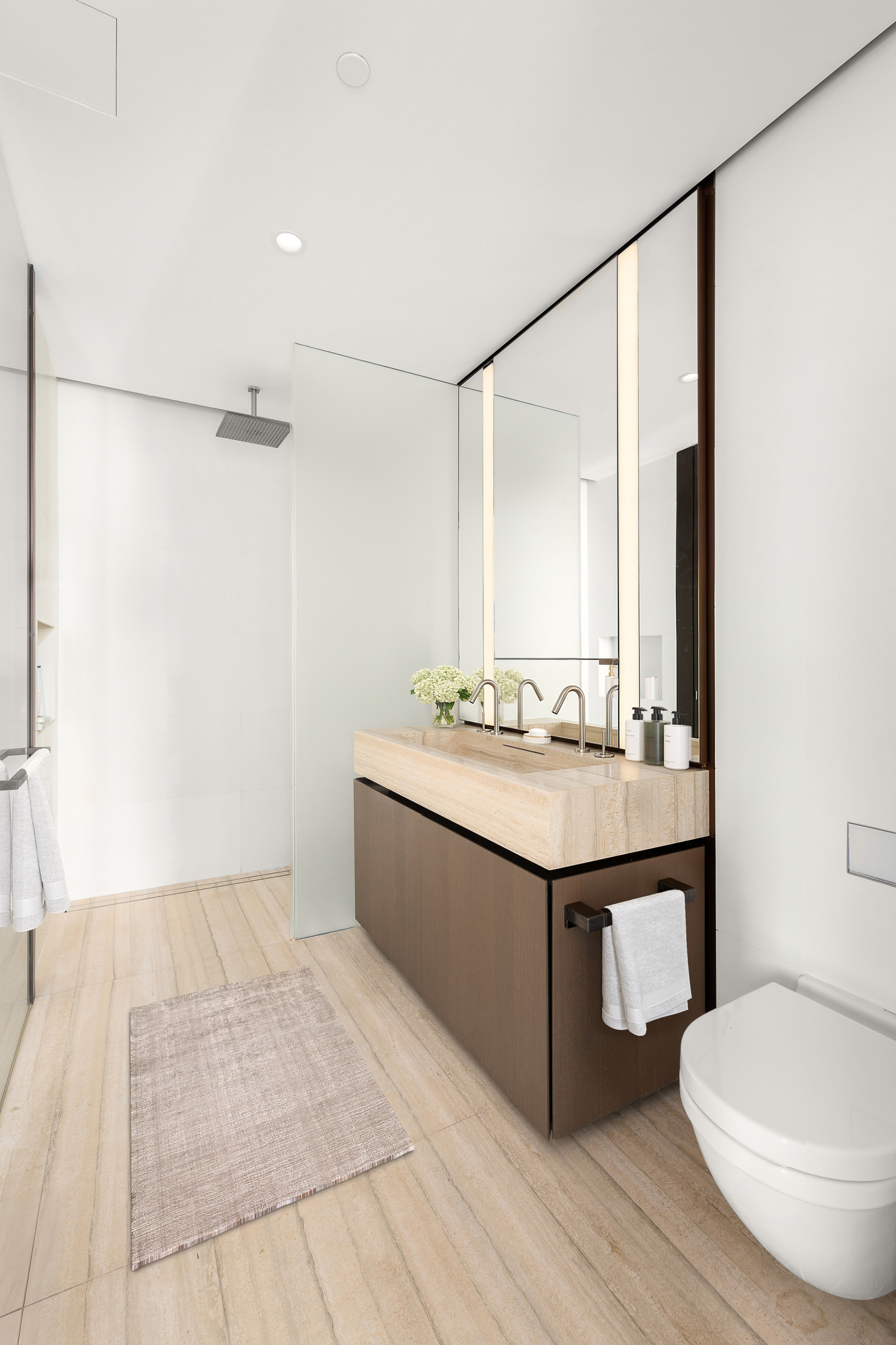 100 East 53rd Street, Unit 40A Manhattan, NY 10022 - Photo 8 of 20 a bathroom with a sink mirror vanity and toilet