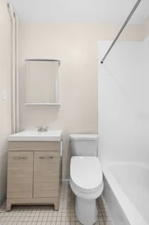 a bathroom with a sink a toilet and bathtub