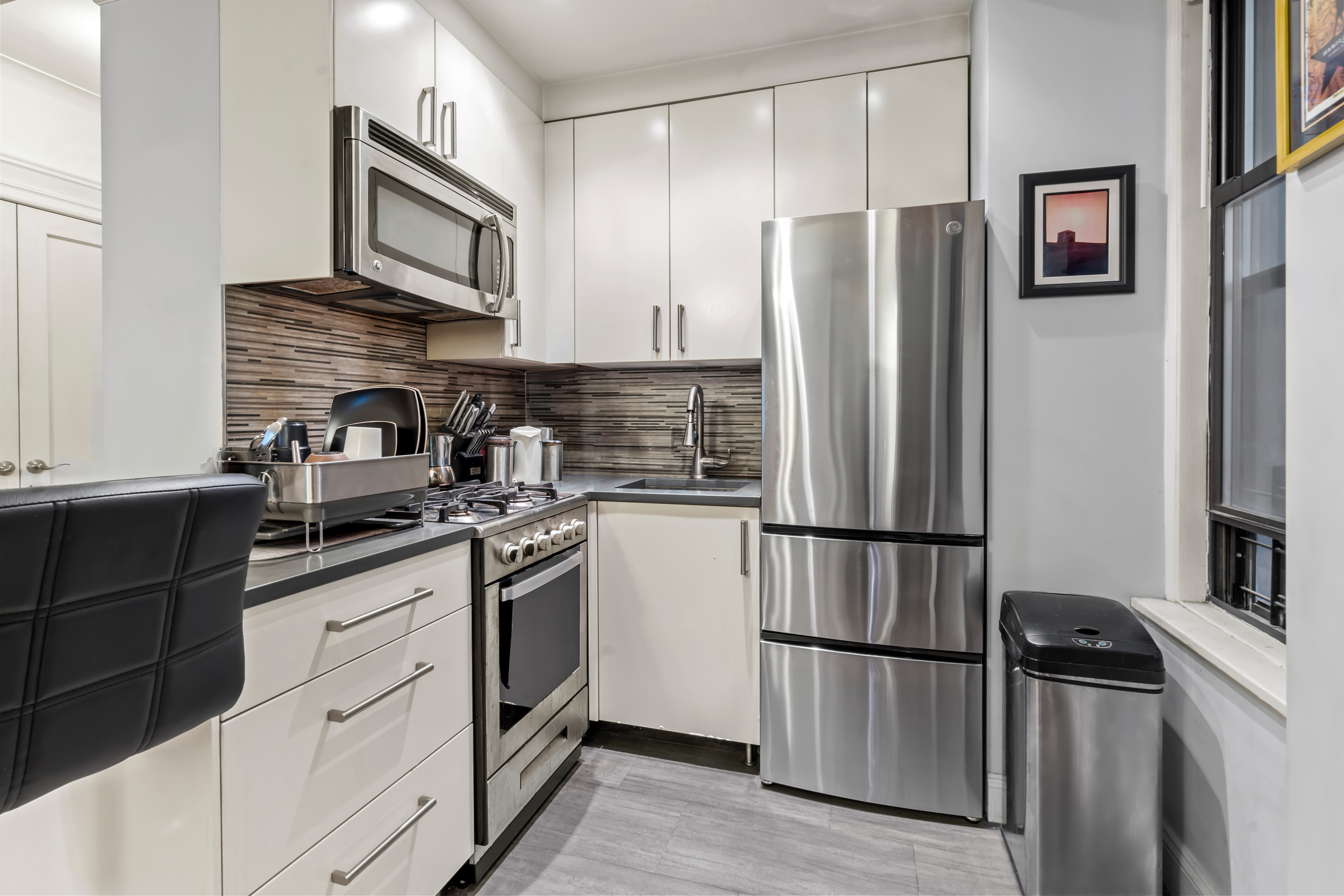 467 Central Park West, Unit 2G Manhattan, NY 10025 - Photo 2 of 10 a kitchen with stainless steel appliances granite countertop a refrigerator stove and sink