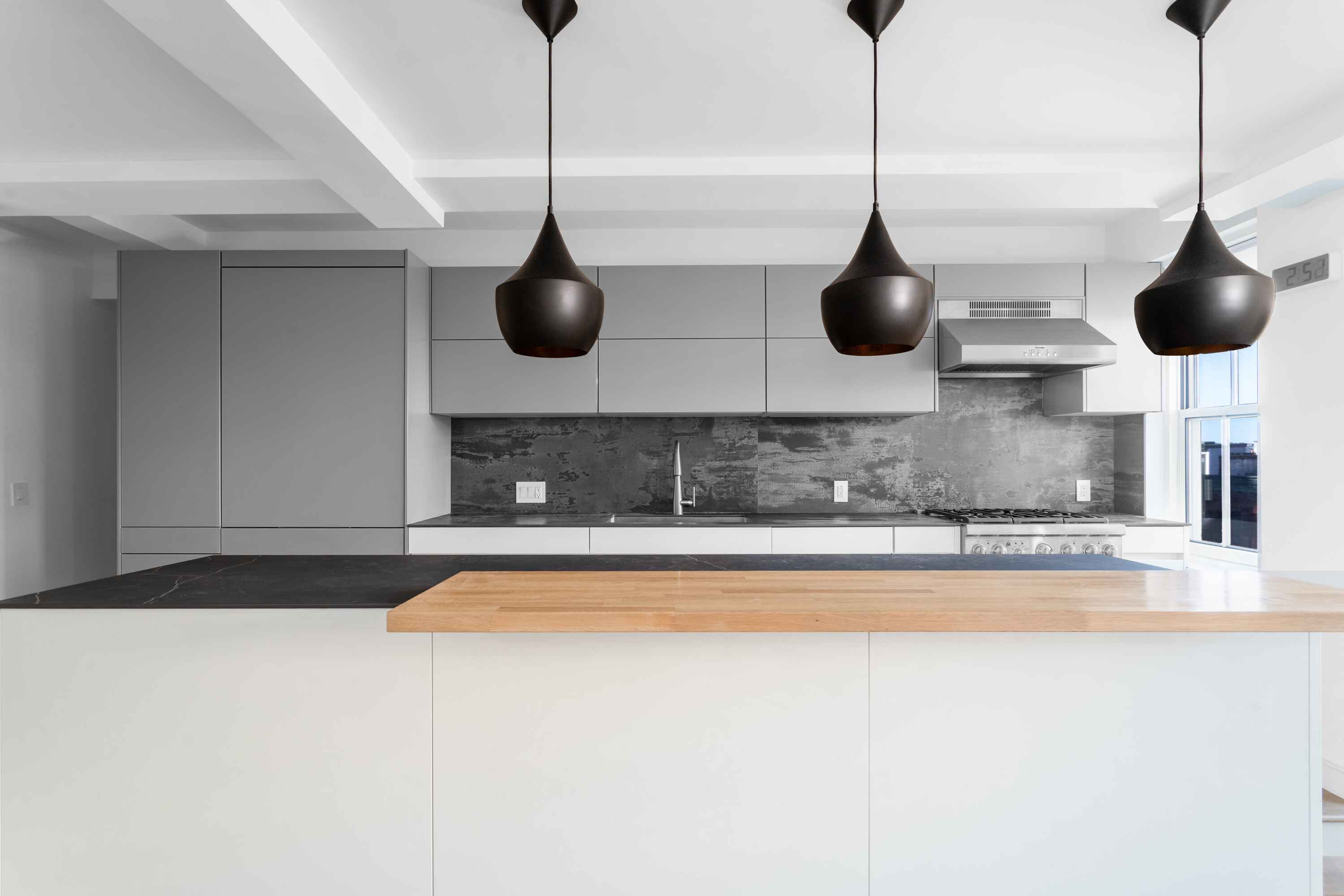 320 West 76th Street, Unit 7DE Manhattan, NY 10023 - Photo 4 of 21 a kitchen with stainless steel appliances granite countertop a sink a stove and a wooden floor