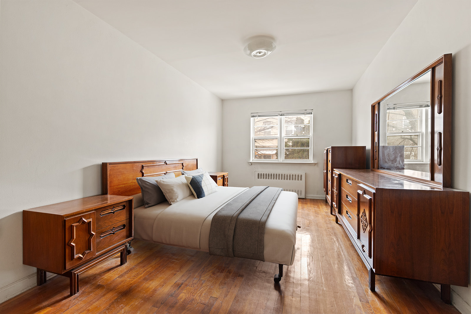 612 17th Street Brooklyn, NY 11218 - Photo 2 of 12 a bedroom with a bed and wooden floor