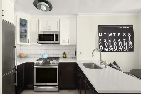 a kitchen that has a sink and a stove