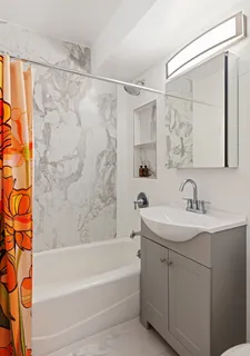 a bathroom with a sink mirror toilet and bathtub