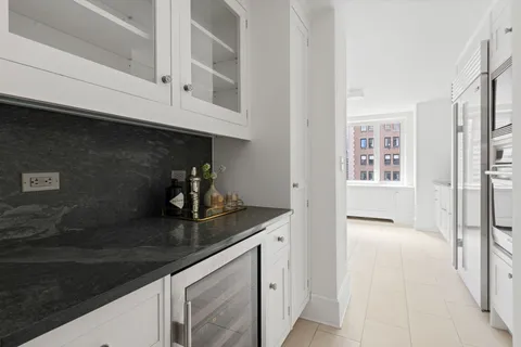 a kitchen with stainless steel appliances granite countertop a sink and dishwasher with white cabinets
