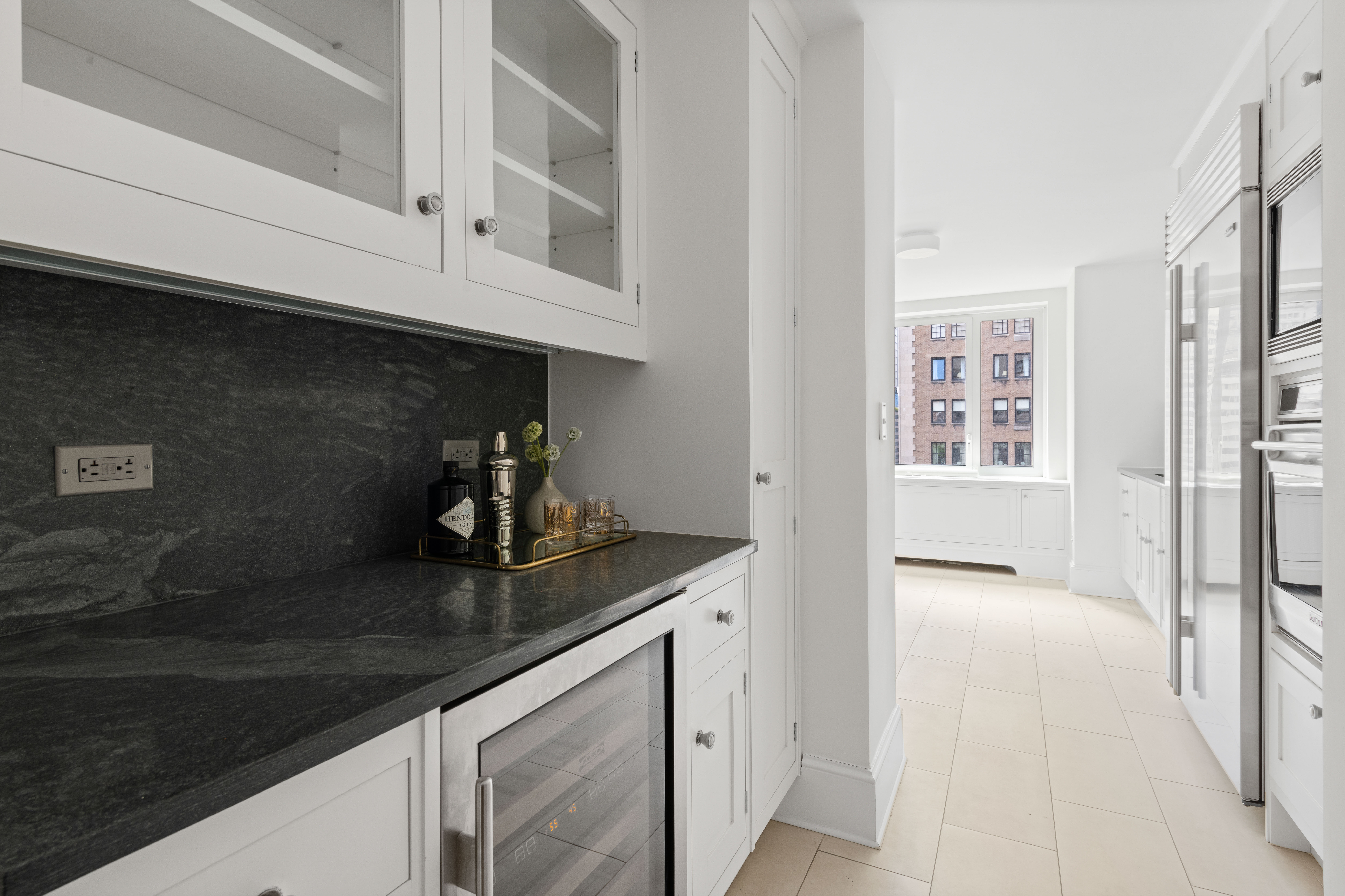 530 Park Avenue, Unit 12A Manhattan, NY 10065 - Photo 11 of 27 a kitchen with stainless steel appliances granite countertop a sink and dishwasher with white cabinets