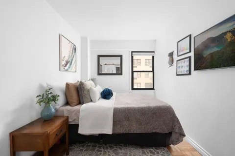 a bedroom with a bed and a couch