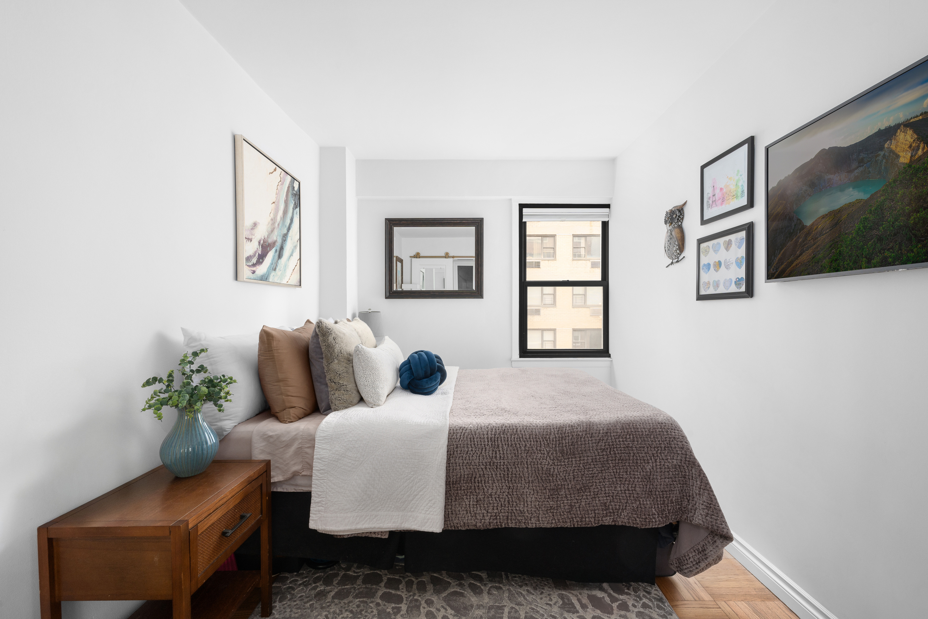 333 East 66th Street, Unit 8C Manhattan, NY 10065 - Photo 8 of 13 a bedroom with a bed and a couch