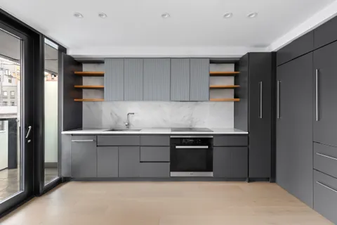 a kitchen with granite countertop a refrigerator and a sink