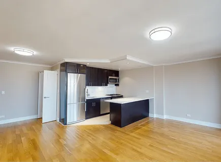 a view of kitchen and refrigerator