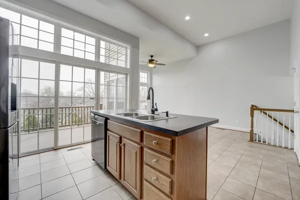 a kitchen with a sink and large windows