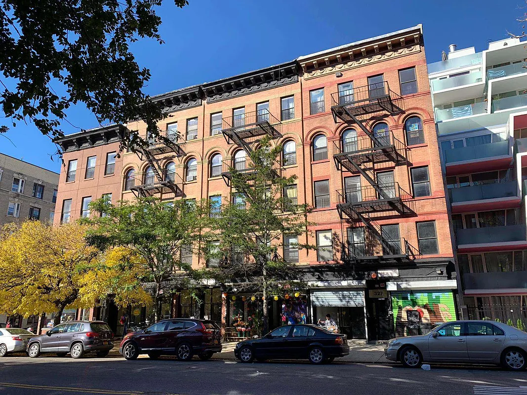 a couple of cars parked in front of a building