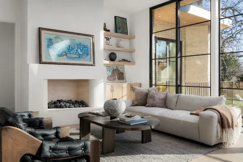 a kitchen with granite countertop a table chairs stove a refrigerator and cabinets