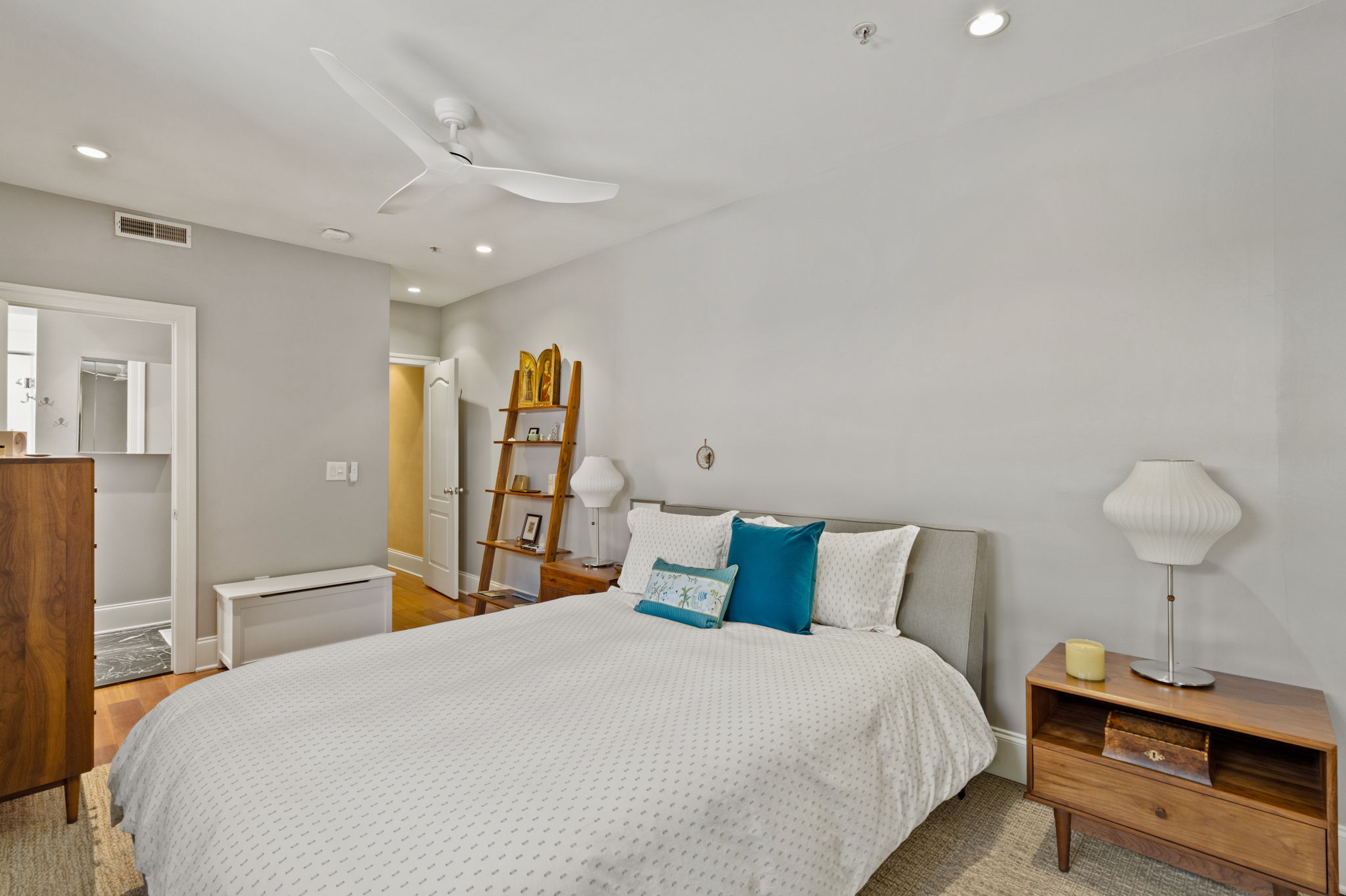 2049 Walnut Street, Unit 1R Philadelphia, PA 19103 - Photo 12 of 18 a bedroom with a bed and a lamp on table