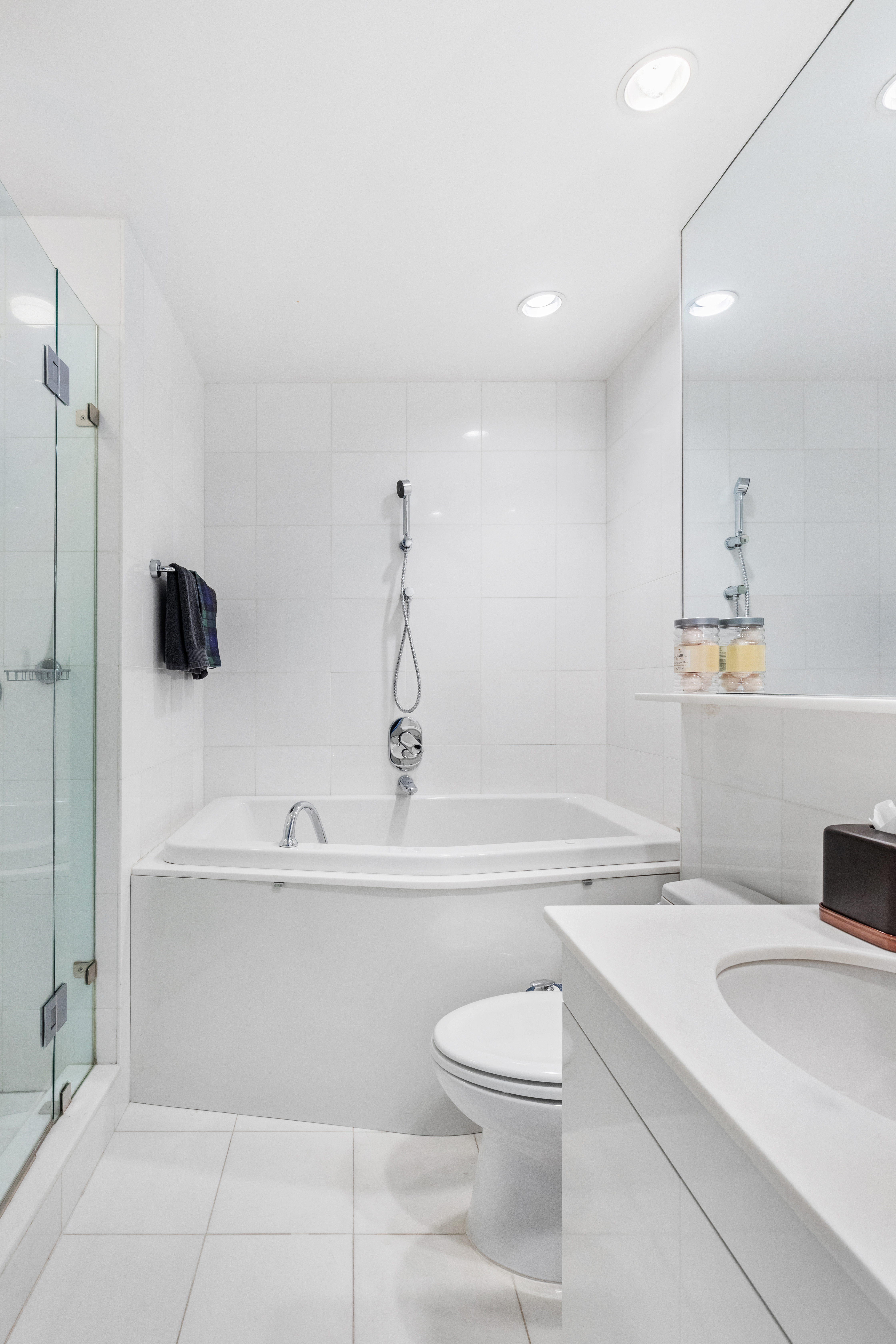 160 West 66th Street, Unit 42AB Manhattan, NY 10023 - Photo 8 of 15 a bathroom with a sink a toilet and a tub