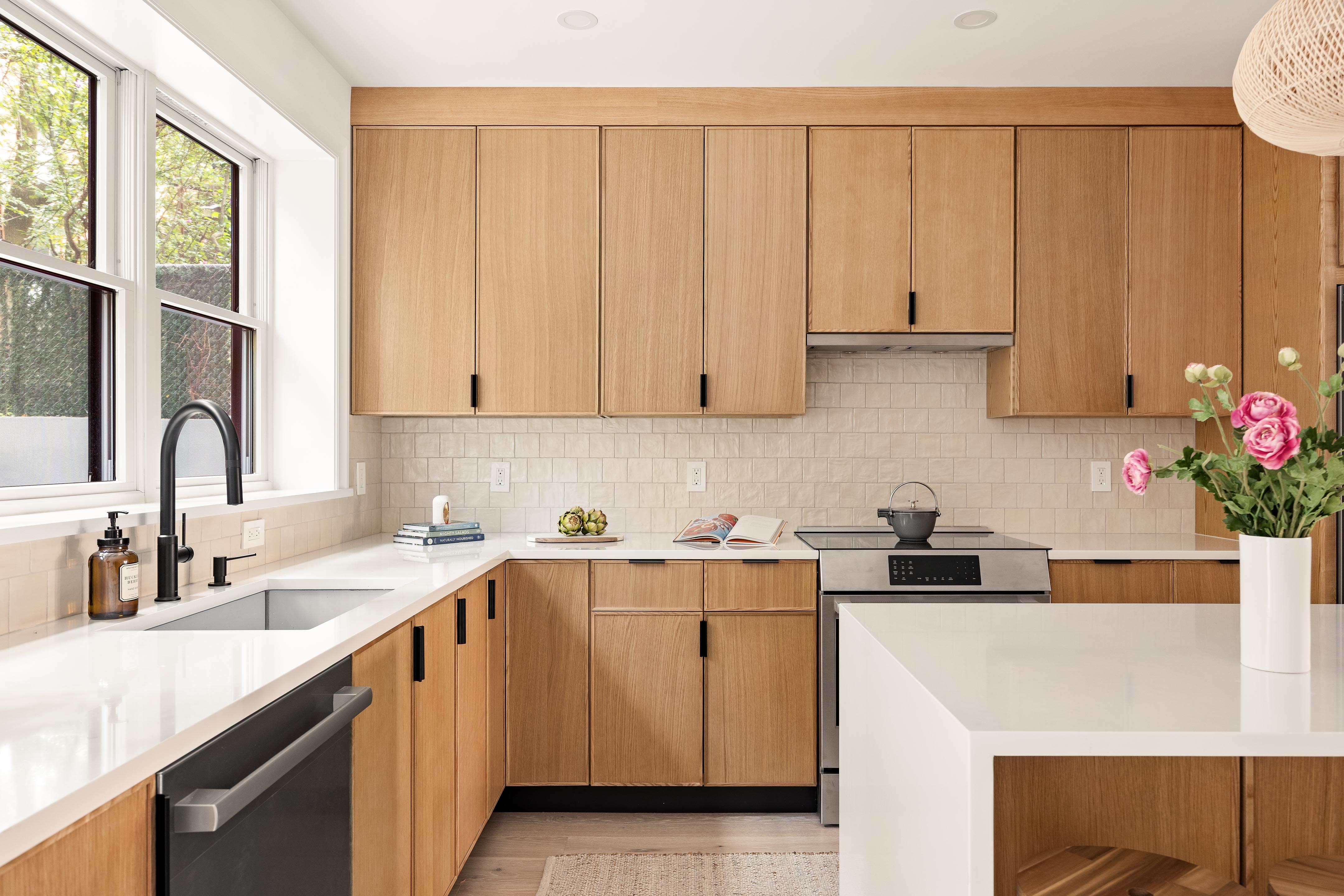578 20th Street Brooklyn, NY 11218 - Photo 3 of 24 a kitchen with stainless steel appliances granite countertop a sink a stove and white cabinets