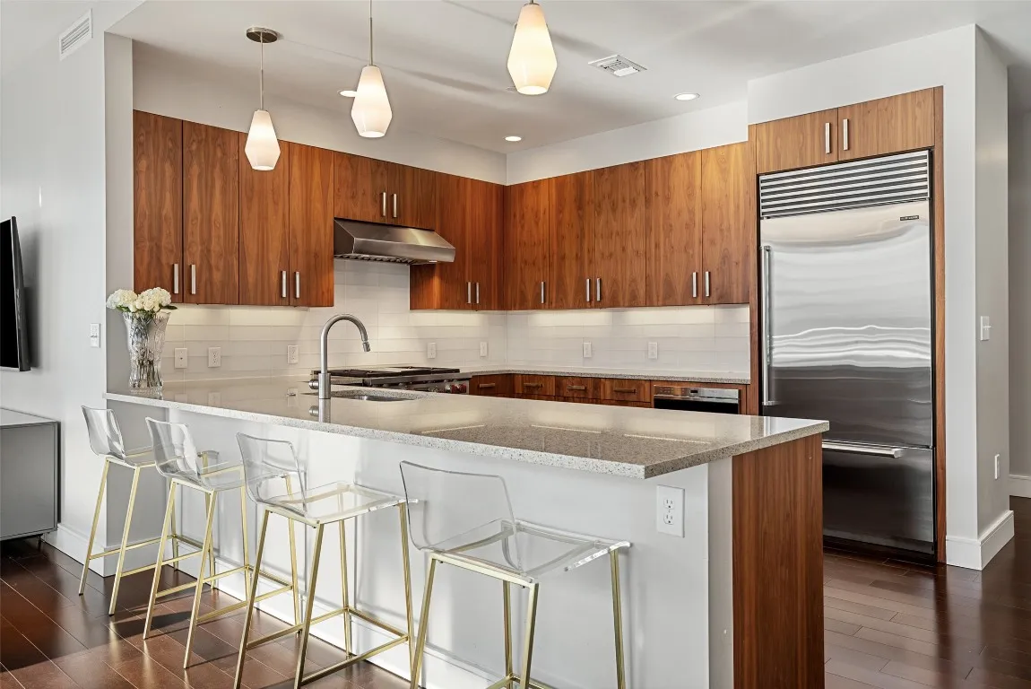 a kitchen with a stove a sink and a refrigerator