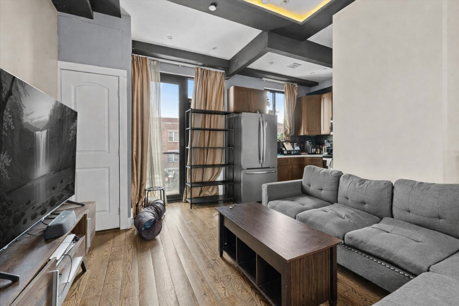 a living room with furniture and a flat screen tv