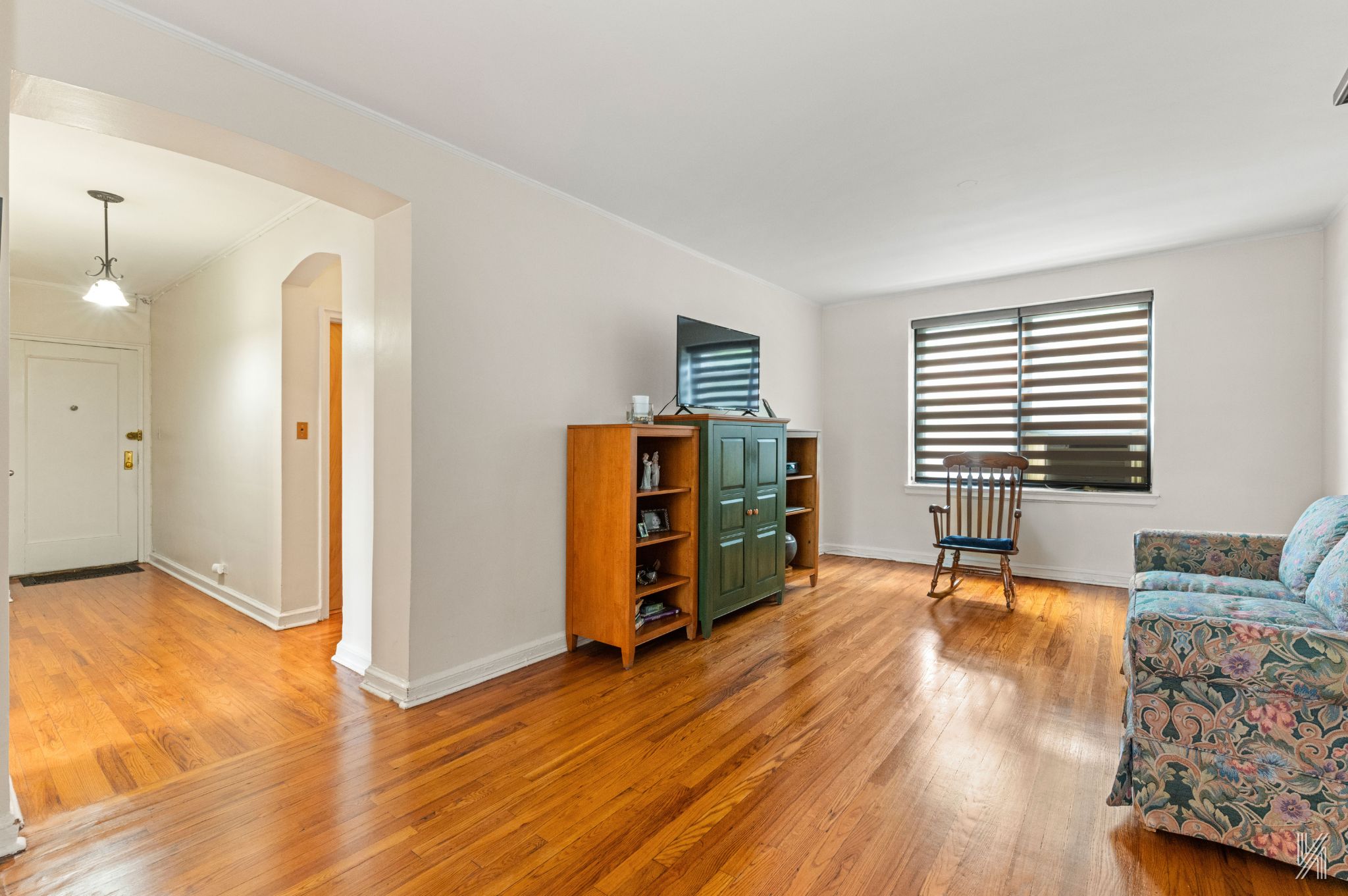 22-08 76th Street, Unit D2 Queens, NY 11370 - Photo 5 of 20 a living room with furniture and a flat screen tv