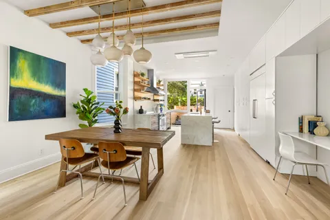 a view of a dining room with furniture window and wooden floor