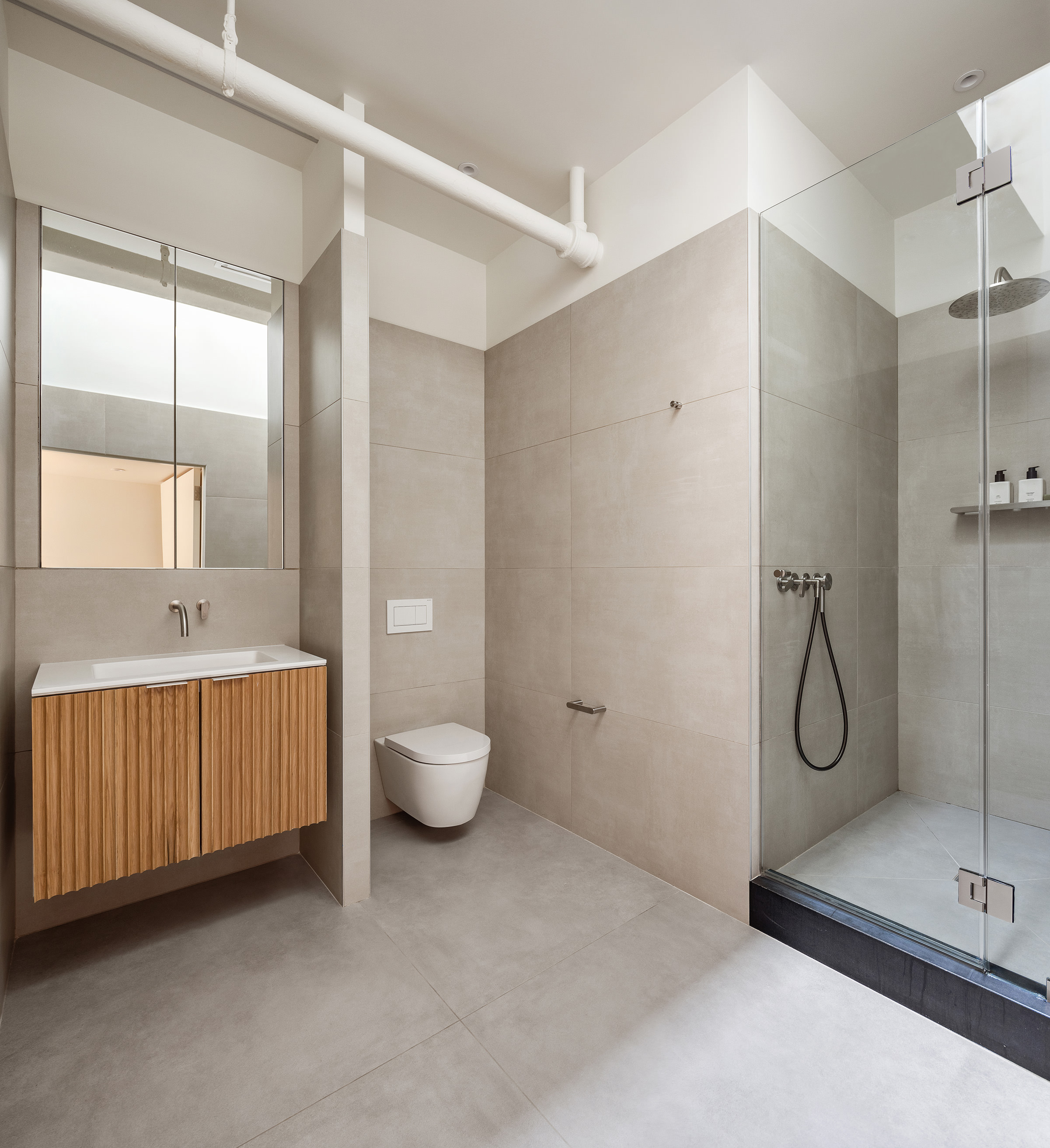 477 Broome Street Manhattan, NY 10013 - Photo 12 of 18 a bathroom with a granite countertop sink a toilet and shower