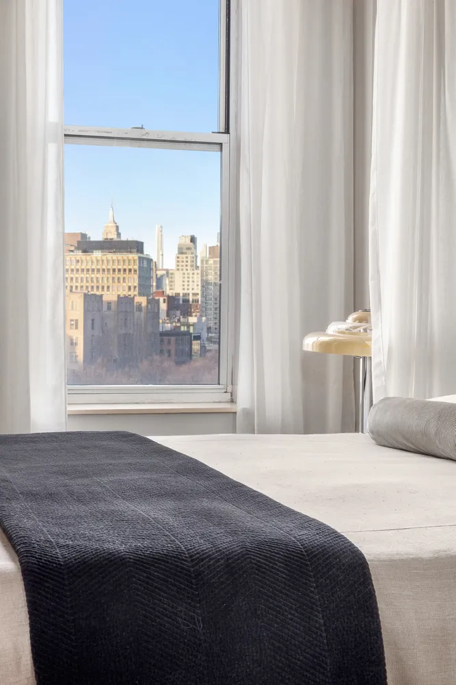 a bedroom with a bed and a window