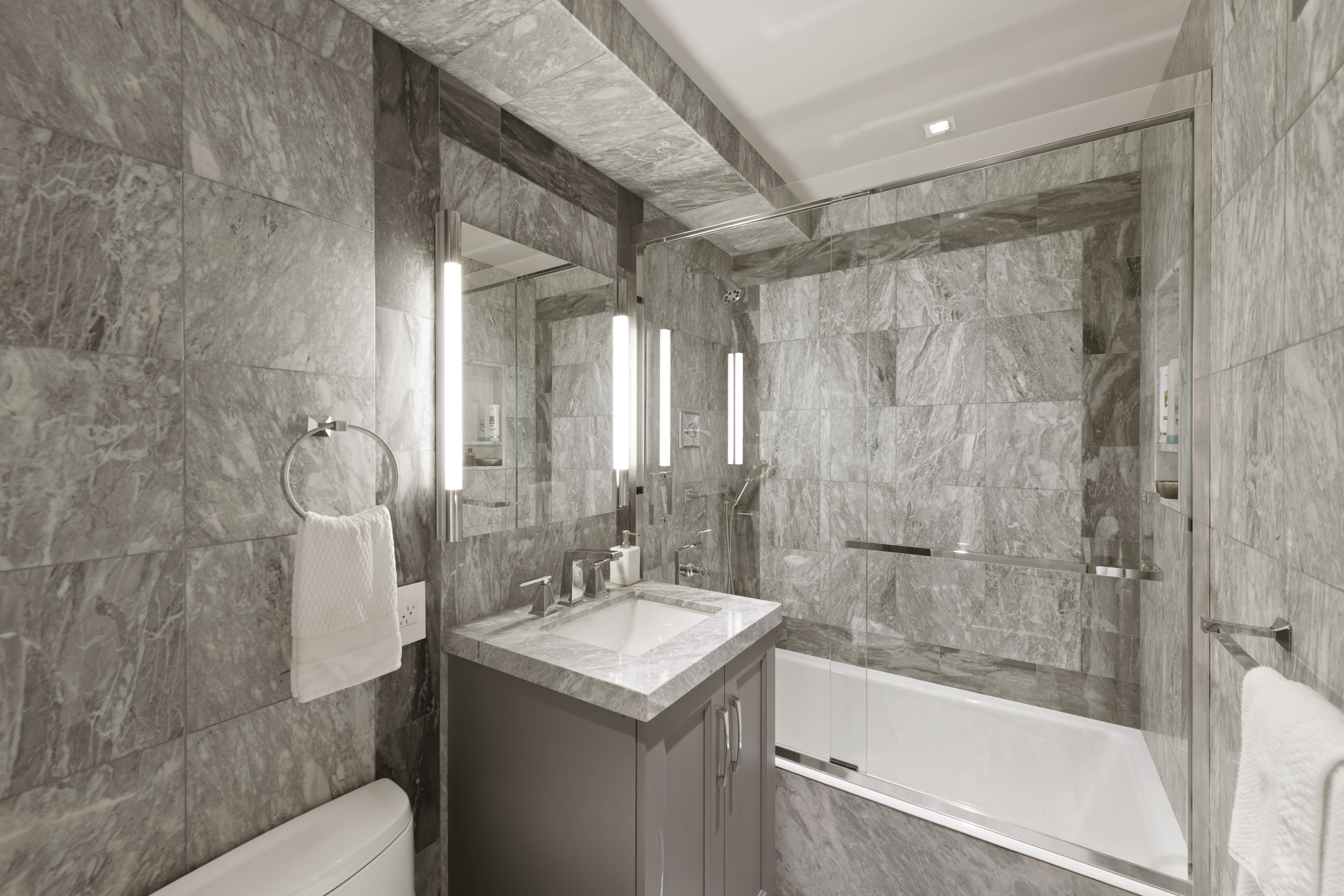 180 East End Avenue, Unit 15E Manhattan, NY 10128 - Photo 13 of 31 a bathroom with a granite countertop sink toilet and shower