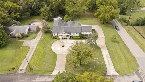 a view of a swimming pool with a yard