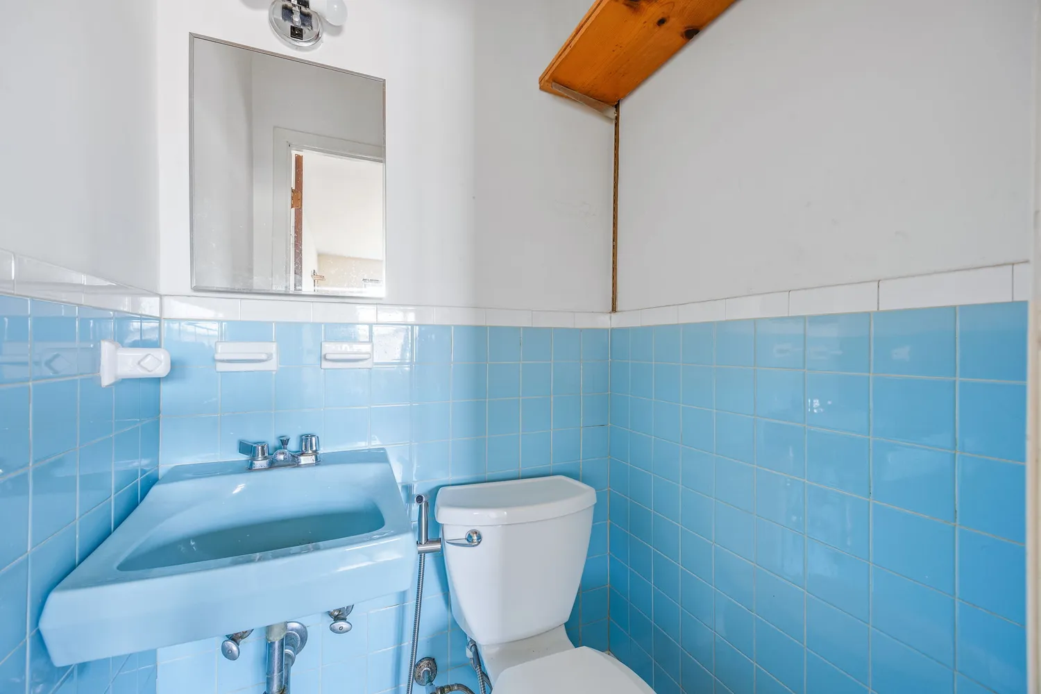 a bathroom with a sink a toilet and mirror