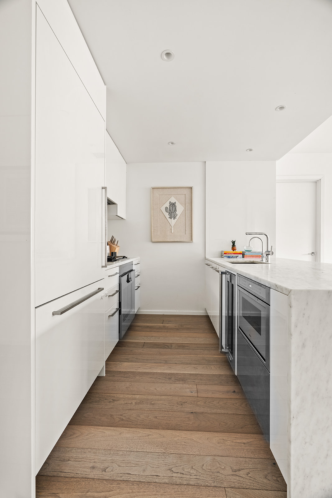 150 East 23rd Street, Unit 5D Manhattan, NY 10010 - Photo 3 of 12 a kitchen with granite countertop a refrigerator and a stove top oven