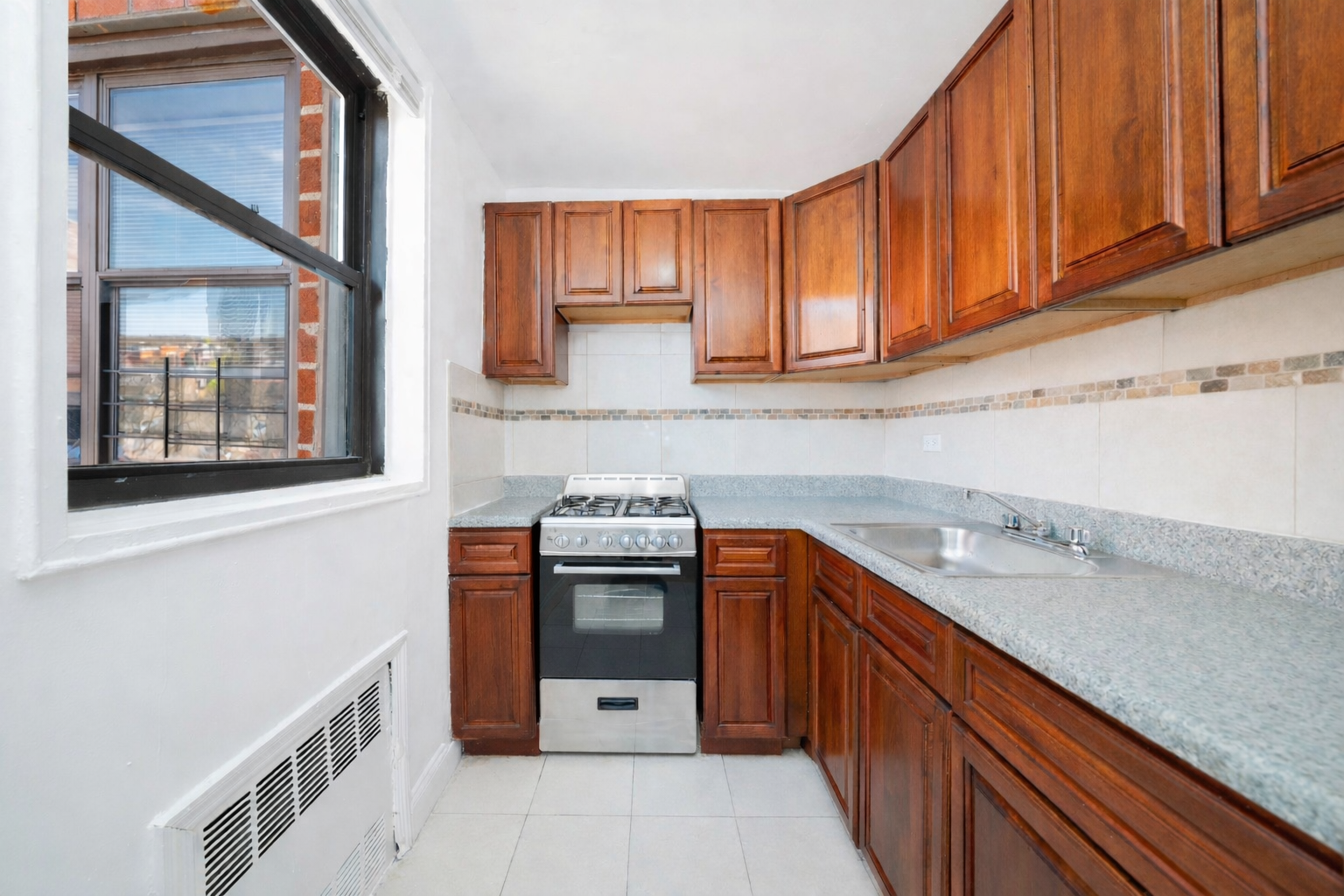 1270 East 51st Street, Unit 6M Brooklyn, NY 11234 - Photo 5 of 12 a kitchen with stainless steel appliances granite countertop a sink stove and cabinets