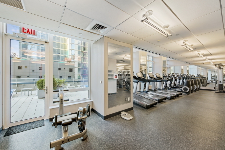 247 West 46th Street, Unit 3103 Manhattan, NY 10036 - Photo 12 of 14 a view of a room with gym equipment