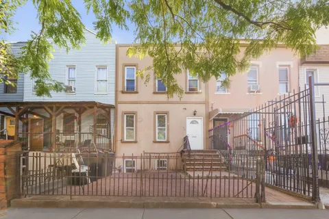 a view of a brick house with a large windows