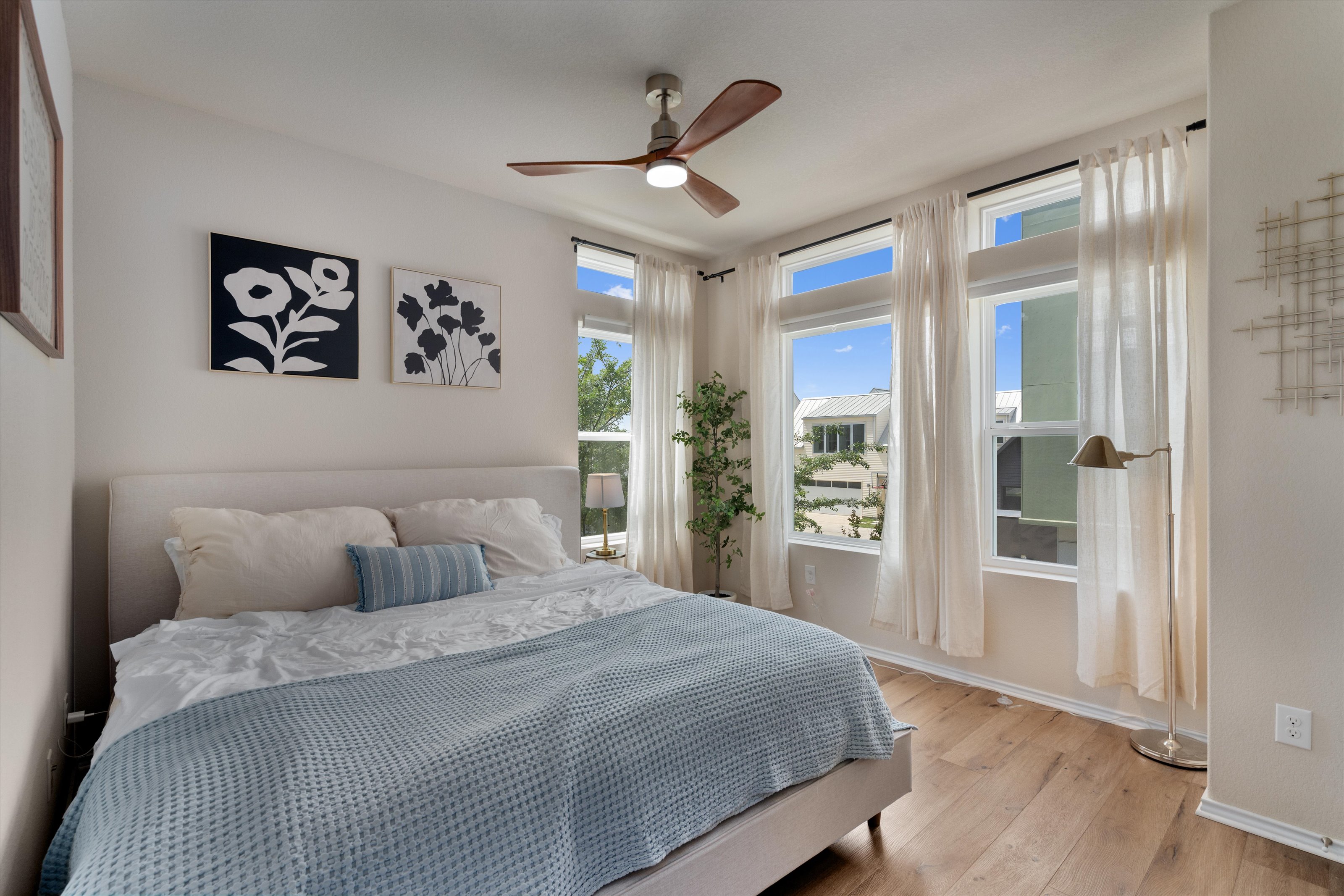 4330 Olenick Street Austin, TX 78723 - Photo 5 of 29 a bedroom with a large bed and a chandelier