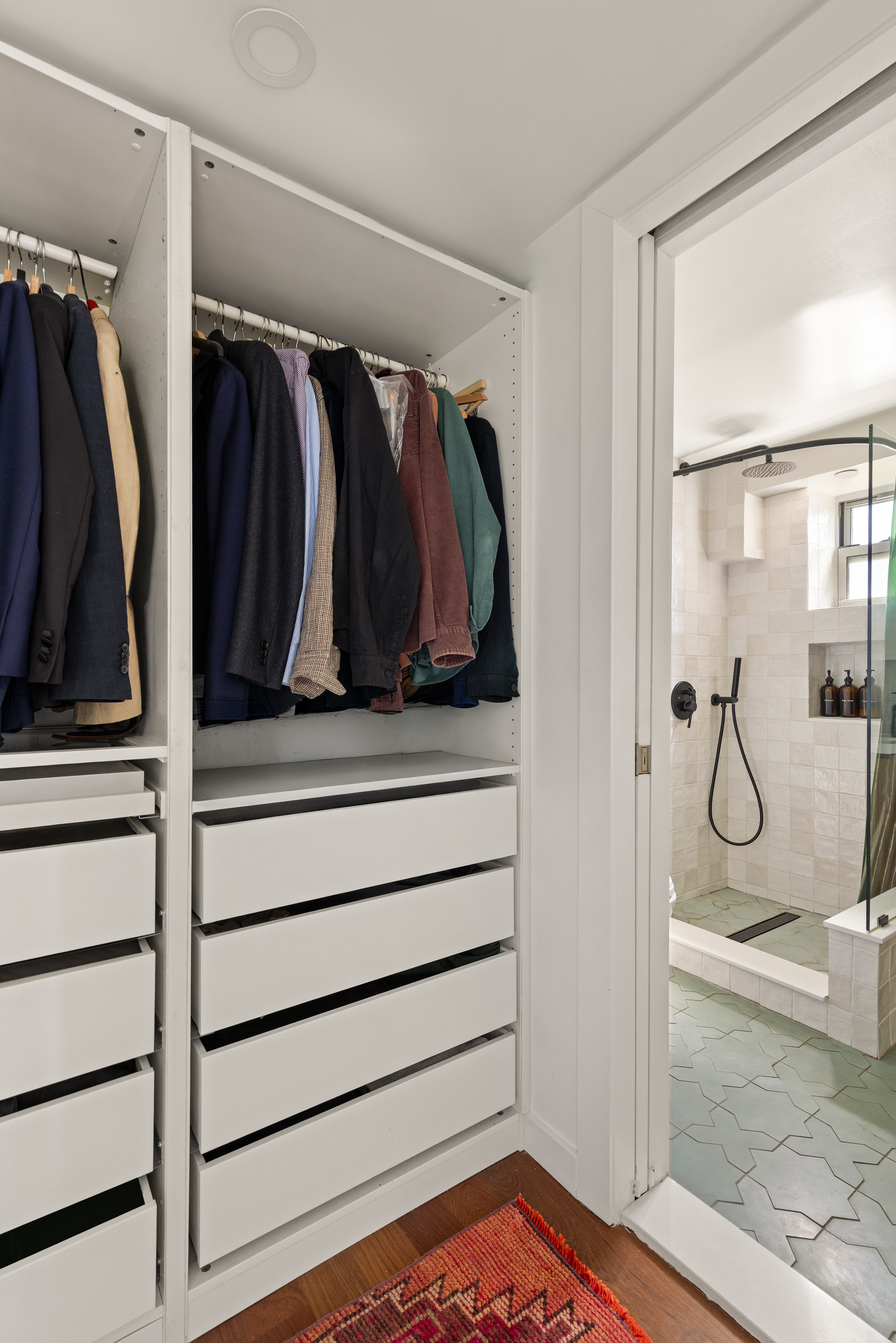 335 Warren Street, Unit 401 Brooklyn, NY 11201 - Photo 9 of 15 a view of walk in closet with clothes and shoes