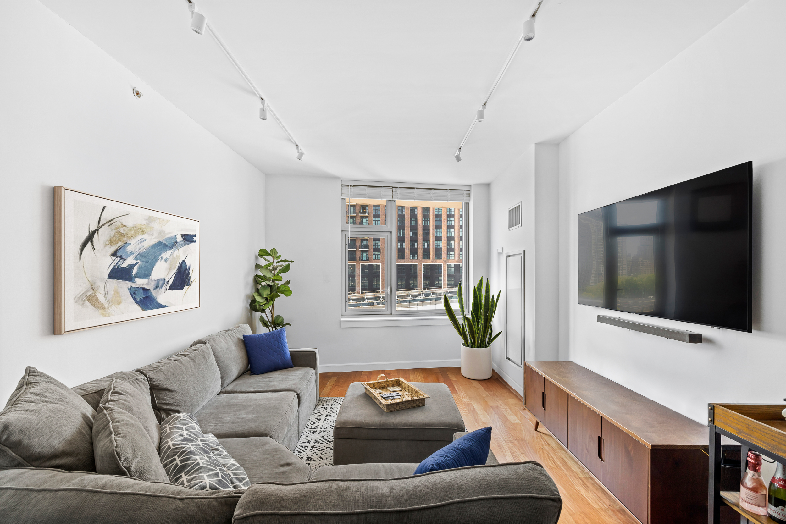 100 Jay Street, Unit 12K Brooklyn, NY 11201 - Photo 2 of 14 a living room with furniture and a flat screen tv