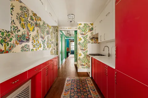 a hallway with a large kitchen stove and wooden cabinets
