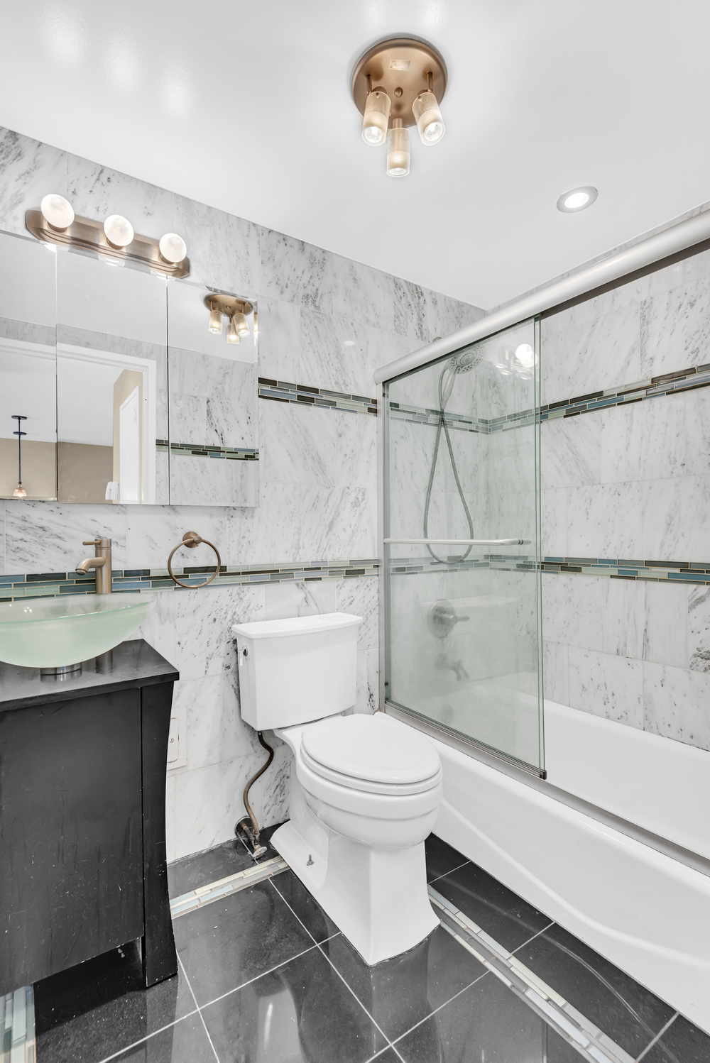 270 West 17th Street, Unit 8B Manhattan, NY 10011 - Photo 3 of 6 a bathroom with a sink a toilet and shower