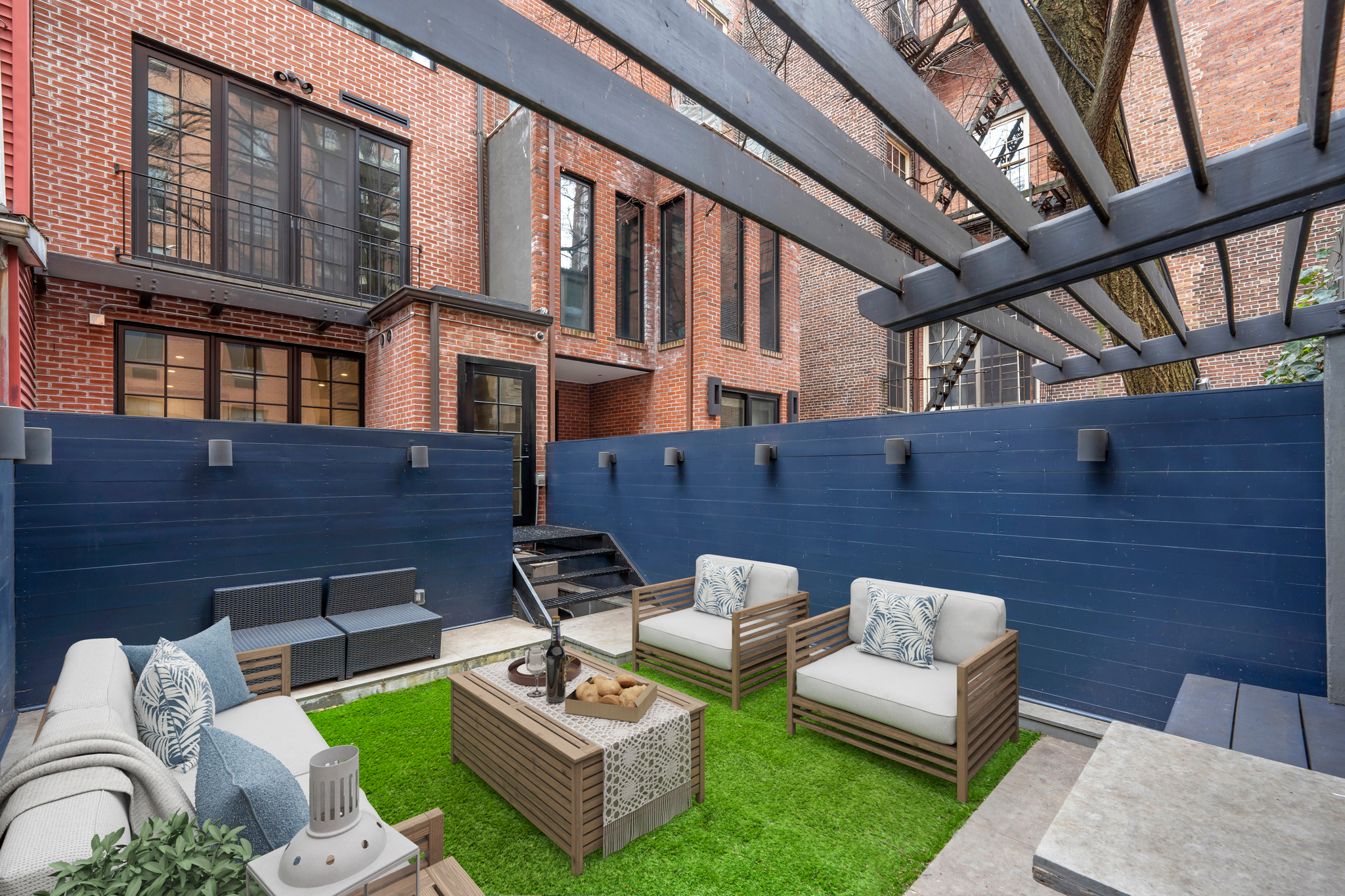 440 West 20th Street Manhattan, NY 10011 - Photo 22 of 35 a view of a patio with couches table and chairs with plants and wooden floor