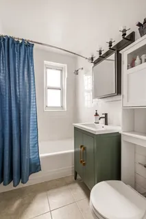 a bathroom with a sink a toilet and bathtub
