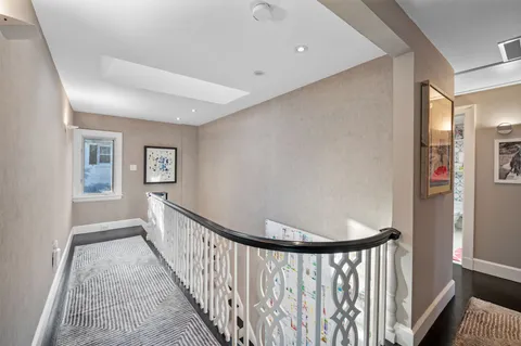 a spacious bathroom with a granite countertop tub mirror and windows