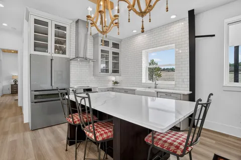 a kitchen with a table chairs and a refrigerator