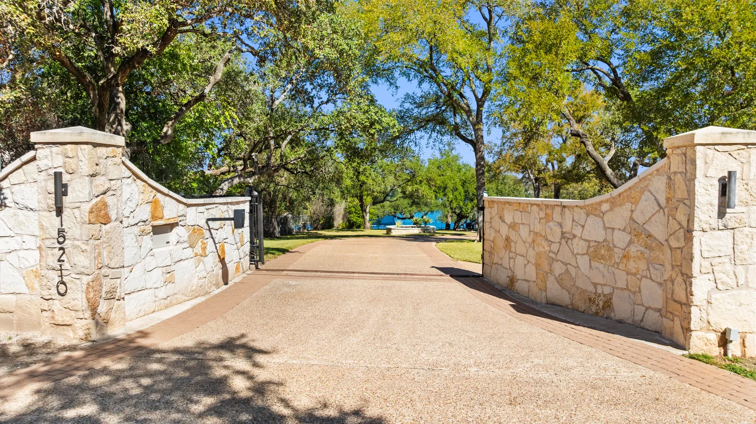a view of a swimming pool with lawn chairs under an umbrella