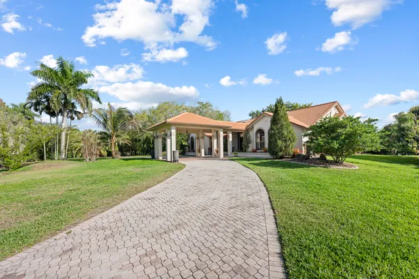 a front view of house with yard and green space