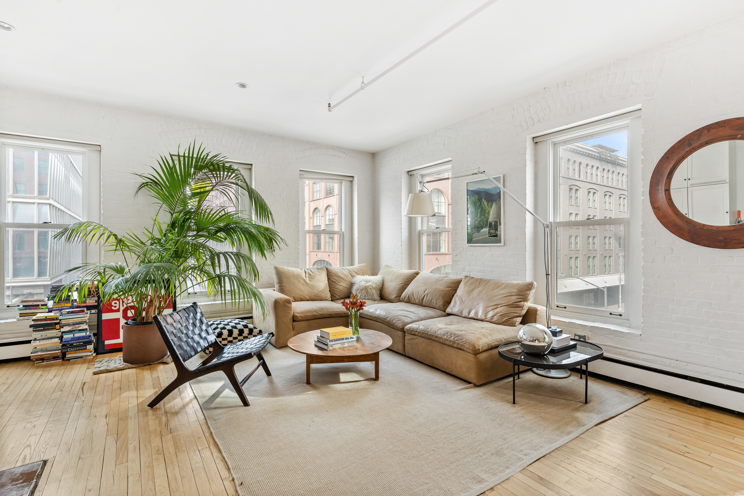 19 Hubert Street, Unit 3 Manhattan, NY 10013 - Photo 1 of 8 a living room with furniture and a window