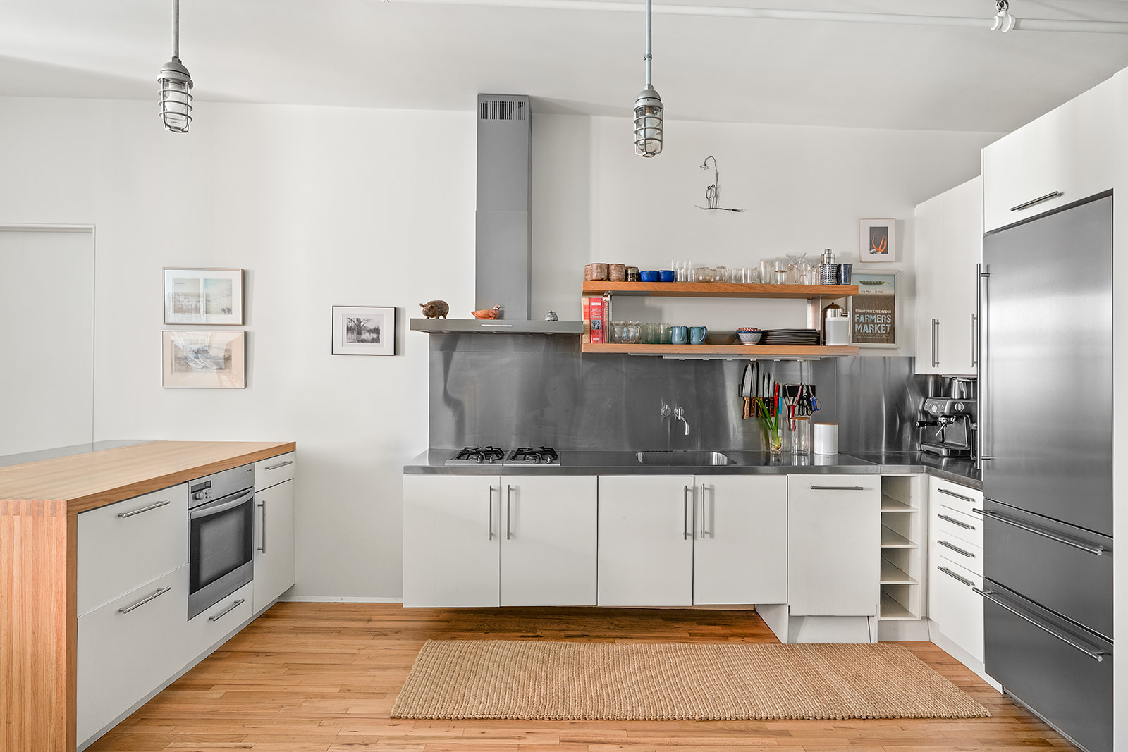 10 Leonard Street, Unit 3N Manhattan, NY 10013 - Photo 6 of 10 a kitchen with stainless steel appliances a stove a refrigerator and cabinets