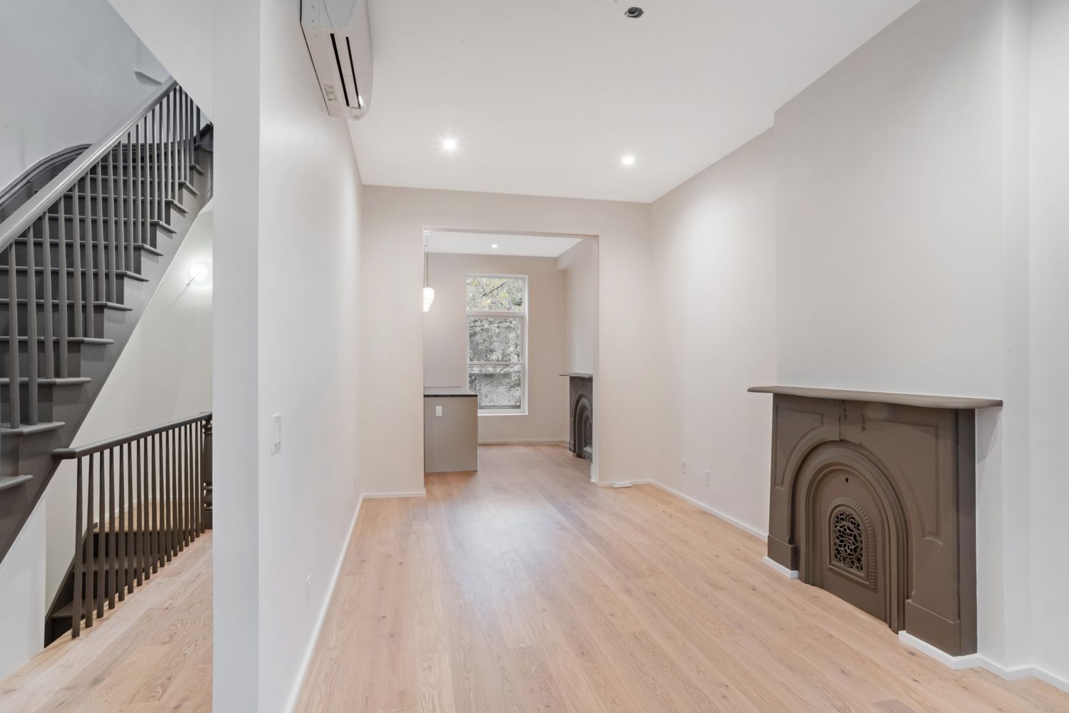 42 Monroe Street Brooklyn, NY 11238 - Photo 3 of 21 a view of a hallway with wooden floor and staircase