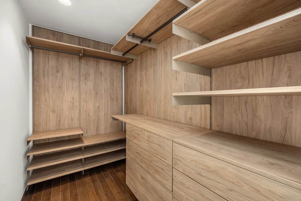 a view of walk in closet with empty racks